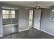 Bright bedroom featuring a large mirrored closet, ceiling fan, wood-look tile flooring, and fresh neutral paint at 3826 Clover Ln, Sarasota, FL 34233