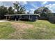 Charming single story home featuring a covered entrance, manicured shrubs, and a well kept lawn at 3826 Clover Ln, Sarasota, FL 34233