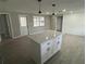 This newly remodeled kitchen features a center island, and wood-look tiling that compliments the neutral color pallet at 3826 Clover Ln, Sarasota, FL 34233