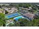 Aerial view of community featuring tennis court, pool, shuffleboard and mature landscaping at 390 301 W Blvd # 13A, Bradenton, FL 34205