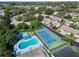Community aerial view showcasing the pool, tennis courts, and low-maintenance villas in a lush setting at 390 301 W Blvd # 13A, Bradenton, FL 34205