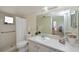 Bright bathroom features a walk-in shower, white vanity, and decorative accents at 390 301 W Blvd # 13A, Bradenton, FL 34205