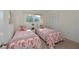 Light-filled bedroom offers two twin beds with flamingo-themed bedding and ample closet space at 390 301 W Blvd # 13A, Bradenton, FL 34205