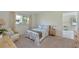 Comfortable bedroom featuring natural light, carpeted floors, and floral accents at 390 301 W Blvd # 13A, Bradenton, FL 34205