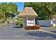 Community entrance gate with well-maintained landscaping and clear signage at 390 301 W Blvd # 13A, Bradenton, FL 34205