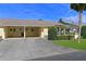 Well-kept home exterior featuring an attached carport and tidy front yard landscaping at 390 301 W Blvd # 13A, Bradenton, FL 34205