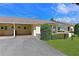 Lovely villa exterior featuring a driveway, carport, and well-kept landscaping at 390 301 W Blvd # 13A, Bradenton, FL 34205