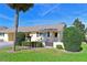 Charming front yard with lush landscaping, inviting seating, and a well-manicured lawn at 390 301 W Blvd # 13A, Bradenton, FL 34205