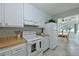 Charming kitchen design with access to an adjoining breakfast area and white appliances at 390 301 W Blvd # 13A, Bradenton, FL 34205