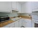 Kitchen showcasing white cabinets and countertops with modern appliances at 390 301 W Blvd # 13A, Bradenton, FL 34205