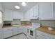 Efficient kitchen design with ample white cabinetry and laminate countertops at 390 301 W Blvd # 13A, Bradenton, FL 34205