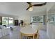 Bright living room featuring tile floors, ceiling fan, large windows, and dining table at 390 301 W Blvd # 13A, Bradenton, FL 34205