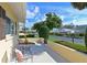 Cozy front patio with seating, complemented by manicured shrubs, offering a peaceful outdoor space at 390 301 W Blvd # 13A, Bradenton, FL 34205