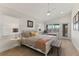 Bright bedroom featuring neutral tones, a white ceiling fan, and natural lighting at 3924 Riverview Blvd, Bradenton, FL 34209