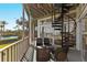 Relaxing screened patio with ceiling fan, spiral staircase and seating overlooking the water at 3924 Riverview Blvd, Bradenton, FL 34209