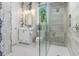 Modern bathroom features a glass enclosed shower, designer wallpaper, and contemporary fixtures at 412 Pheasant Way, Sarasota, FL 34236