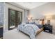 Relaxing bedroom features a woven bed frame, patio access, and matching bedside tables at 412 Pheasant Way, Sarasota, FL 34236