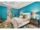 A primary bedroom with a king bed, designer bedside table lamps and en-suite bathroom with tub and shower at 412 Pheasant Way, Sarasota, FL 34236