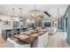 Open-concept dining area with views of kitchen and living area, featuring stylish lighting and ample seating at 412 Pheasant Way, Sarasota, FL 34236