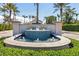 Community entrance featuring a gorgeous fountain and lush landscaping with mature palm trees, welcoming you to Bird Key at 412 Pheasant Way, Sarasota, FL 34236