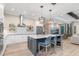 A modern kitchen with stainless steel appliances, a large island, and adjacent living area with comfortable seating at 412 Pheasant Way, Sarasota, FL 34236