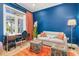Bright living room features a comfortable sofa, stylish decor, and an inviting workspace near a window at 412 Pheasant Way, Sarasota, FL 34236