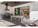 Charming outdoor dining area complete with grill, granite countertop, ceiling fan, and a view into the home at 412 Pheasant Way, Sarasota, FL 34236