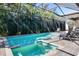 Inviting pool and spa area provides a tropical oasis and features multiple lounge chairs for relaxation at 412 Pheasant Way, Sarasota, FL 34236