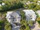 Aerial view of a waterfront home with manicured landscaping and private dock at 449 Canal Rd # 449, Sarasota, FL 34242