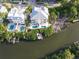 Aerial view of waterfront home with boat dock and lush landscaping at 449 Canal Rd # 449, Sarasota, FL 34242