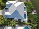 Aerial view of a home with a pristine white roof, pool, patio, dock, and waterfront access at 449 Canal Rd # 449, Sarasota, FL 34242