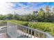 Scenic balcony view of a canal surrounded by verdant trees and nearby docks at 449 Canal Rd # 449, Sarasota, FL 34242