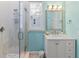 Bathroom featuring a glass shower, bright blue wall, and marble vanity at 449 Canal Rd # 449, Sarasota, FL 34242