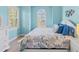 Inviting bedroom featuring a large arched window, light-blue walls and coastal-themed decor at 449 Canal Rd # 449, Sarasota, FL 34242