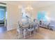 Dining area with hardwood floors, chandelier and coastal décor open to the kitchen at 449 Canal Rd # 449, Sarasota, FL 34242