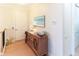 Entry hallway featuring beach-themed art and a wood console table at 449 Canal Rd # 449, Sarasota, FL 34242