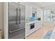 Kitchen features stainless steel appliances, tile backsplash, and white cabinets at 449 Canal Rd # 449, Sarasota, FL 34242