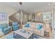 Open-concept living room features hardwood floors and coastal décor with staircase and foyer at 449 Canal Rd # 449, Sarasota, FL 34242