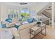 Living room features hardwood floors and coastal décor with staircase and sliders to patio at 449 Canal Rd # 449, Sarasota, FL 34242