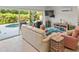 Bright living room with tile flooring, patio access, and beachy decor at 449 Canal Rd # 449, Sarasota, FL 34242