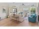 Bright living room with hardwood floors and coastal décor with sliders to the patio at 449 Canal Rd # 449, Sarasota, FL 34242