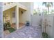 Cozy brick patio entrance with white fencing and lush greenery at 449 Canal Rd # 449, Sarasota, FL 34242