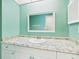 Fresh bathroom featuring granite counter top, vanity with sink and large framed mirror at 4534 La Jolla Dr, Bradenton, FL 34210