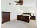 Bedroom with dark wood furniture, ceiling fan, and a closet at 4534 La Jolla Dr, Bradenton, FL 34210