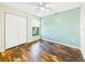 Bright bedroom features hardwood floors, a ceiling fan, and a window with natural light at 4534 La Jolla Dr, Bradenton, FL 34210