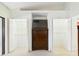 Main bedroom closet with open white bi-fold doors and chest of drawers with TV at 4534 La Jolla Dr, Bradenton, FL 34210