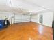 Spacious garage features concrete floors, overhead lights, and additional storage space at 4534 La Jolla Dr, Bradenton, FL 34210