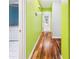 Hallway showing hardwood flooring, and painted walls with doorways leading to rooms at 4534 La Jolla Dr, Bradenton, FL 34210