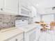 Bright kitchen includes modern appliances and a breakfast nook with seating for four at 4534 La Jolla Dr, Bradenton, FL 34210