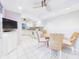 Bright eat-in kitchen features white cabinetry, appliances, and tile flooring and a dining area with seating for four at 4534 La Jolla Dr, Bradenton, FL 34210